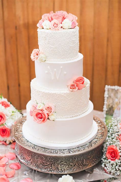 Detailed White Wedding Cake With Coral Roses