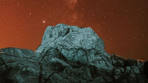 Download Wallpaper 1600x900 Rock Stone Nebula Stars Starry Sky