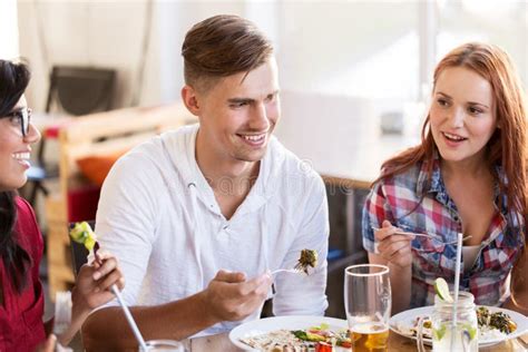 Happy Friends Eating And Talking At Restaurant Stock Image Image Of