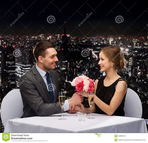 Smiling Man Giving Flower Bouquet To Woman Stock Photo Image Of Happy