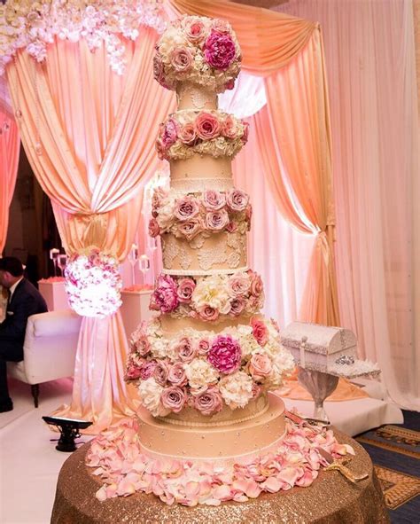 six tiers of fresh flowers with fondant accents and lace adorned thanks la moda photography