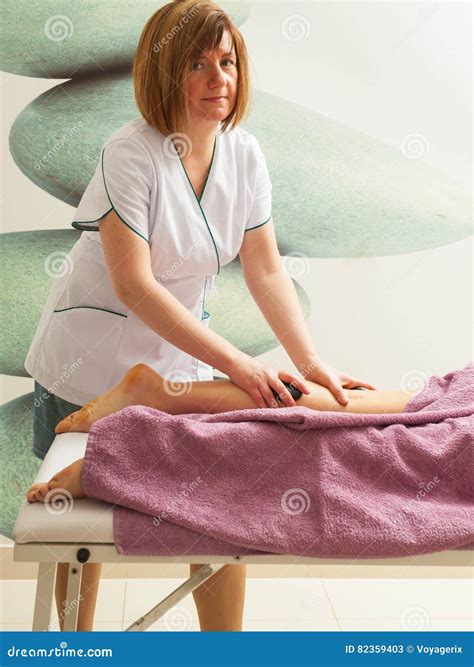 Masseuse Doing Legs Massage With Hot Stones Stock Image Image Of Relax Wellness