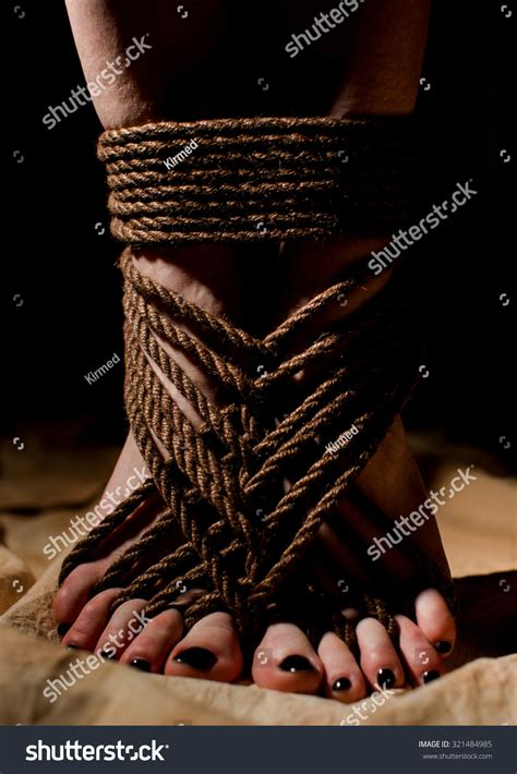 Female Feet Tied With Jute Rope In Japanese Style Of Bondage Or Bdsm Shibari Stock Photo
