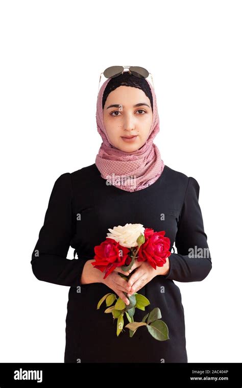 stylish muslim woman in traditional islamic clothing holding flower bouquet portrait of