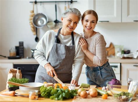 Happy Mother And Daughter Preparing Healthy Food At Home Stock Photo