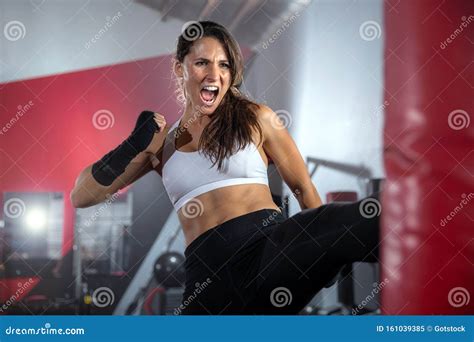 Female Athlete Fighter Training Striking A Bag In Gym Intense Self Defense Mixed Martial Arts
