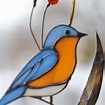 Stained glass bluebird with bass leaves suncatcher