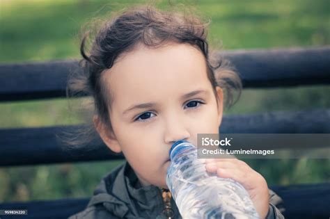 Little Girl Drinking Water From Plastic Bottle Stock Photo Download