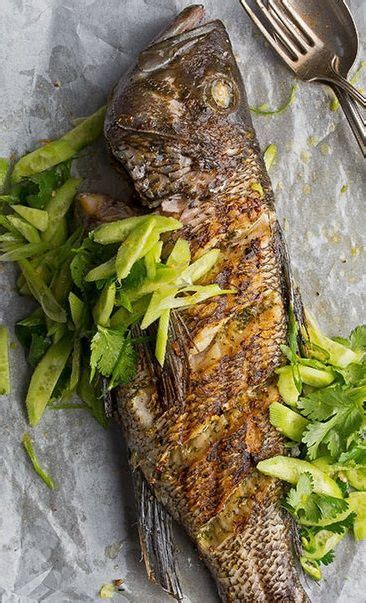 Grilled Whole Black Sea Bass With Asian Inspired Cucumber Cilantro Salad Tastingtable