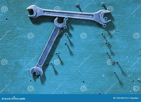 Metal Wrench Hang On The Screws On A Wooden Background Stock Image