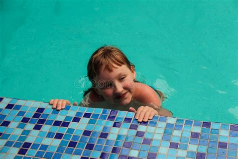 the girl is swimming in the pool near the edge stock image image of relaxation outdoor 189564797