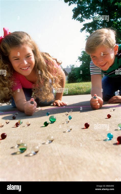 Kids Playing With Marbles Stock Photo Alamy