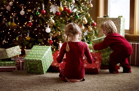 Two Children Opening Ts On Christmas Morning