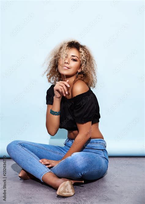 portrait of blissful sexy hot black woman with blond african hairstyle smiling model girl in