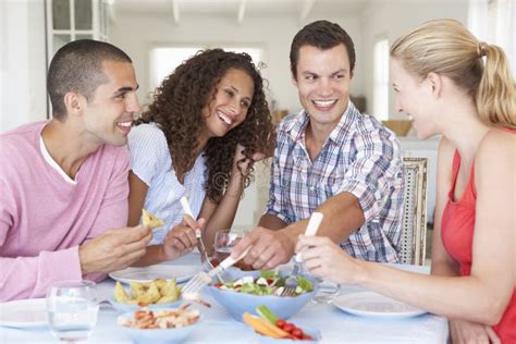 Group Of Young Friends Enjoying Meal Together Stock Photo Image Of
