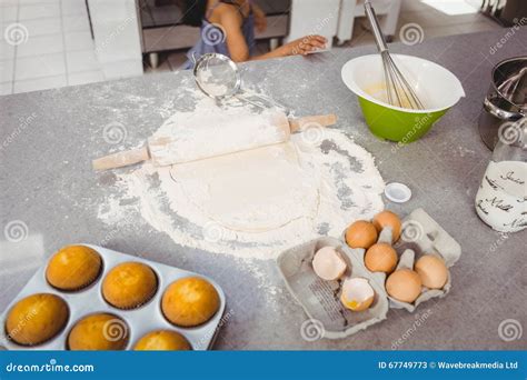 Rolling Pin On Dough With Muffins And Egg At Kitchen Table Stock Image