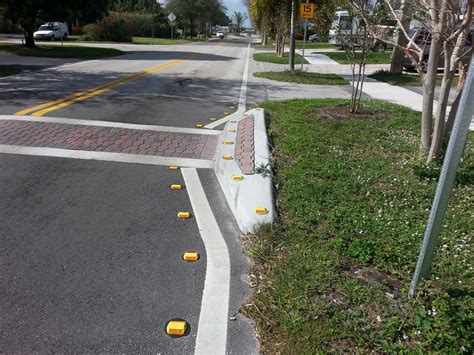 These Traffic Calming Curbs That Project Into Both Lanes That Are