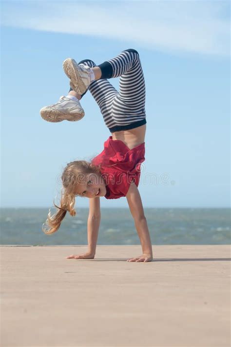 Photo About Happy Little Girl Doing Handstand By The Ocean Image Of