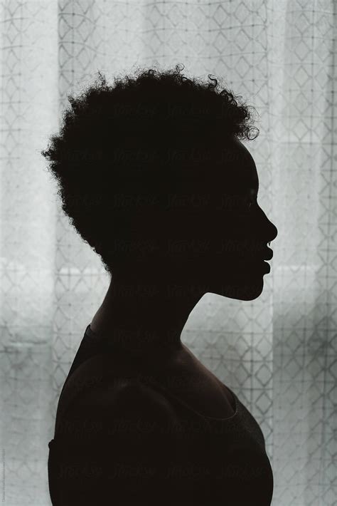 A Young African American Woman In Silhouette By Stocksy Contributor