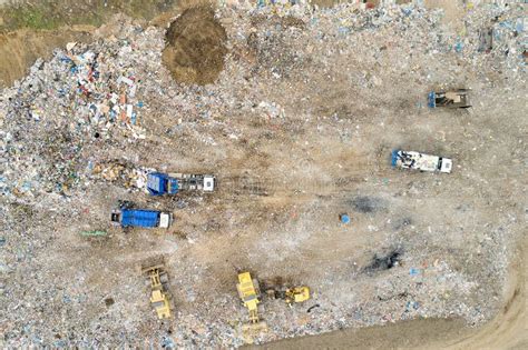 Garbage Pile In Trash Dump Or Landfill Dump Trucks And Excavators