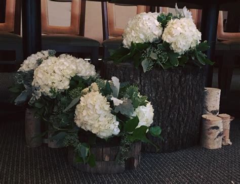 Natural Aisle Marker With White Hydrangea And Natural Wooden Stumps