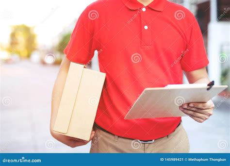 Parcel Delivery Man Of A Package Through A Service Send To Home Stock