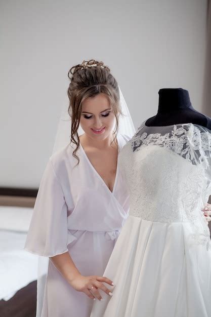 Premium Photo Wedding Bride In Beautiful Robe Near The Mannequin With Dress Indoors At Home