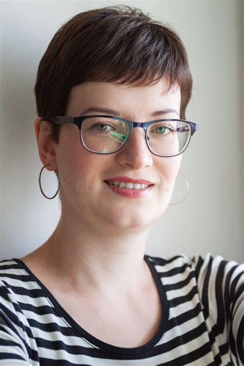 A Short Haired Brunette Looks Straight With A Smile Stock Photo Image