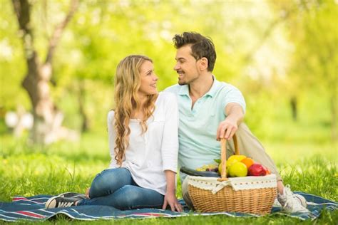 Premium Photo Couple Having Picnic On The Lawn In Summer Park