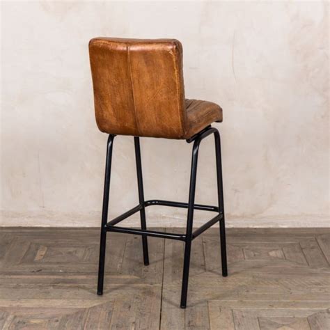 Bar stools are used at the portion of a kitchen counter that is stepped up (usually by 6″) from the rest of the counter. Jenson Distressed Leather Bar Stools -Tan - Trading Boundaries