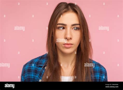 Closeup Portrait Of Positive Brunette Girl In Checkered Shirt Looking With One Crossed Eye