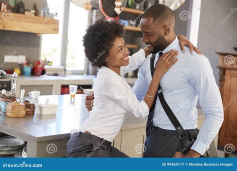 Husband Saying Goodbye To Wife As He Leaves For Work Stock Image