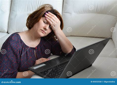 Woman With Headache Uses A Computer At Home Stock Photo Image Of