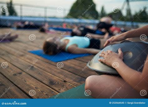 Group Of Young People Practicing Yoga Lesson Lying In Dead Body Or