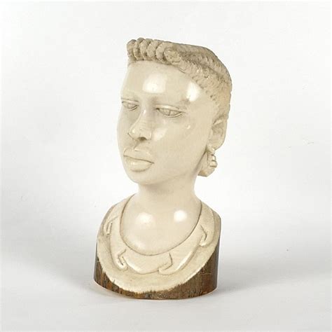 A Carved Ivory Head An African Woman With An Elaborate Hairdo