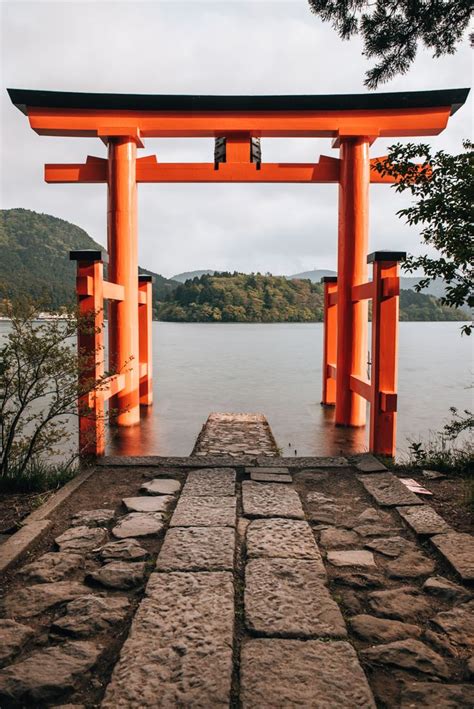 An Orange Gate Is On The Side Of A Body Of Water