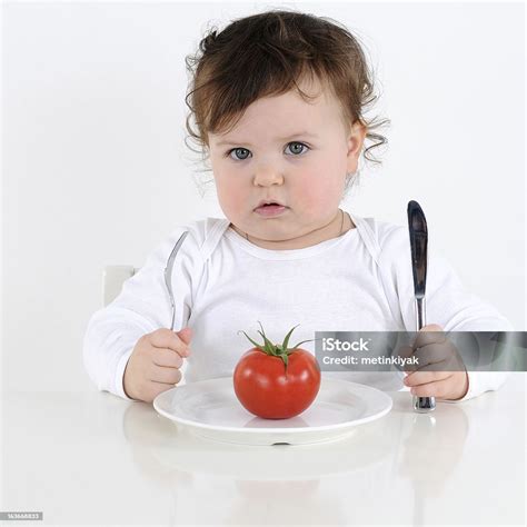 Sweet Baby Girl Eating Tomato Stock Photo Download Image Now Babies