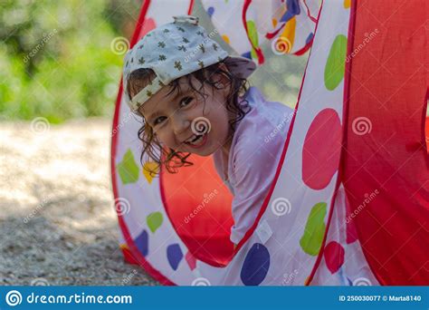 Little Girl With Cap And Pacifier Smiling At Camera Stock Image