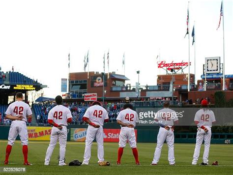 Members Of The Philadelphia Phillies Line Up For The National Anthem