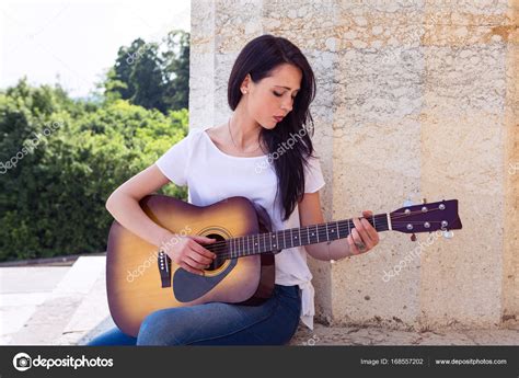 Beautiful Woman Playing Acoustic Guitar — Stock Photo © Alessandroguerr