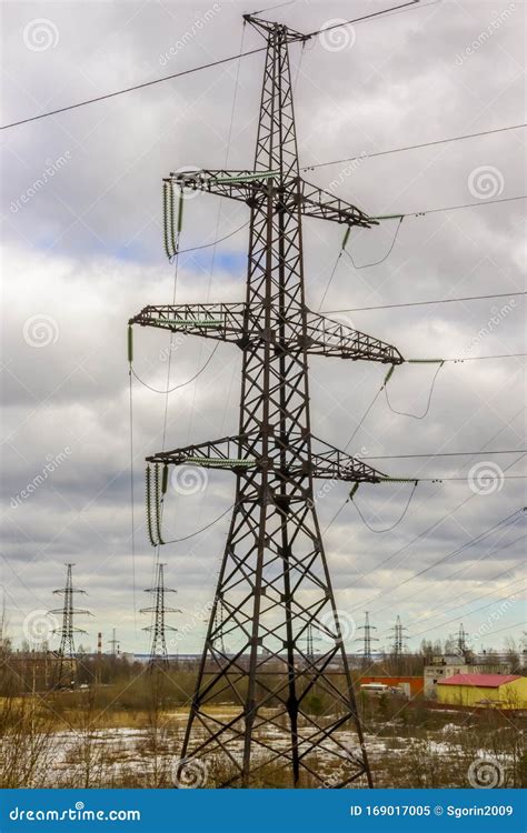 Industrial Landscape Of High Voltage Masts With Electric Cables