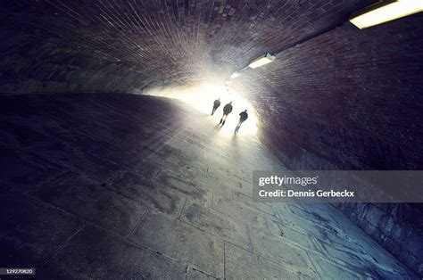 People Walking Into Light High Res Stock Photo Getty Images