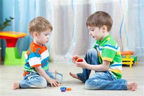 Kids Play With Wooden Toy Sitting On The Floor Stock Photo Image Of