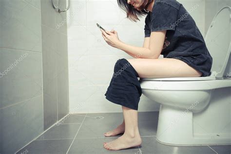 Woman Using A Smartphone On Toilet In Morning — Stock