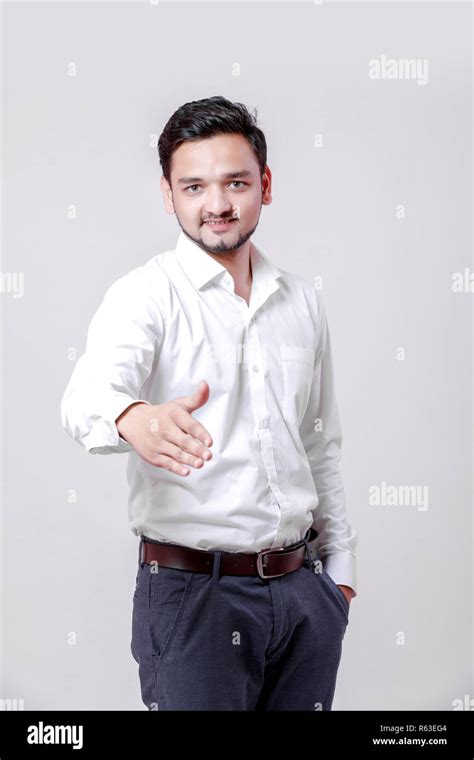 Young Indian Man Making A Deal Over Isolated White Background Stock