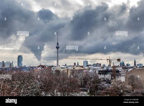 Berlin Skyline With Snow Covered Trees Fernsehturm And Dramatic Cloudy