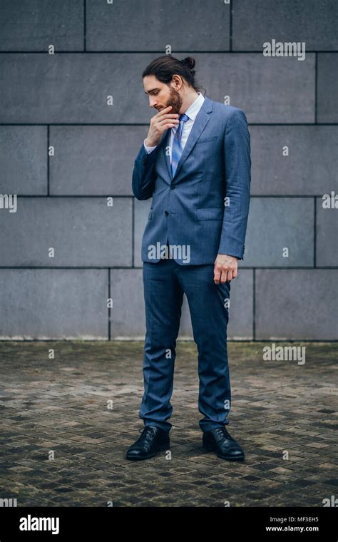 Serious Businessman Standing Outdoors Looking Down Stock Photo Alamy