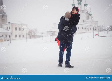 A Loving Couple Walks In Winter On The Background Of Historical Sights