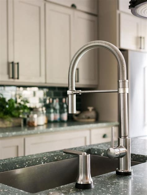 A Kitchen Sink And Faucet With Granite Counter Tops