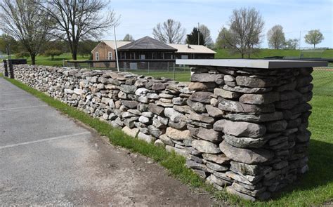 The stone wall as a fence. Stone fence project at town park runs into financial brick ...